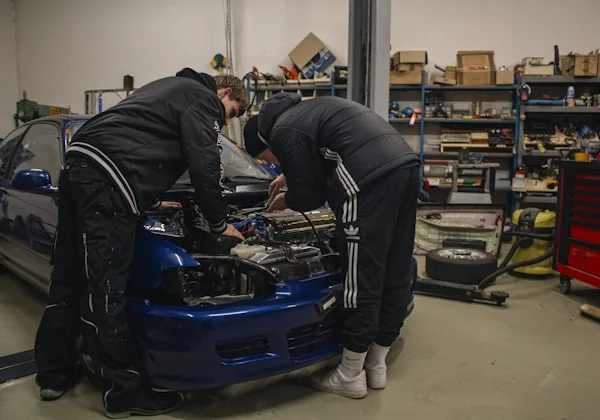 A mechanic working on a car engine in the Brad Ward Motors workshop, Henderson